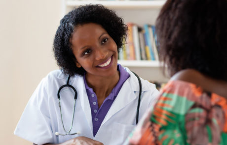 Laughing african american female doctor with patient