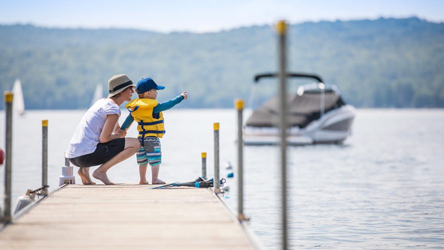 Mother and toddler on a dock in the summertime
