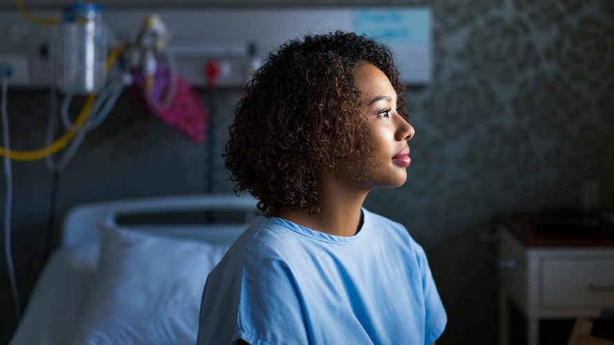 Female hospital patient looking out a window