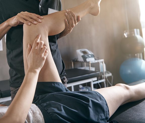 Physiotherapist helping a patient with a knee problem