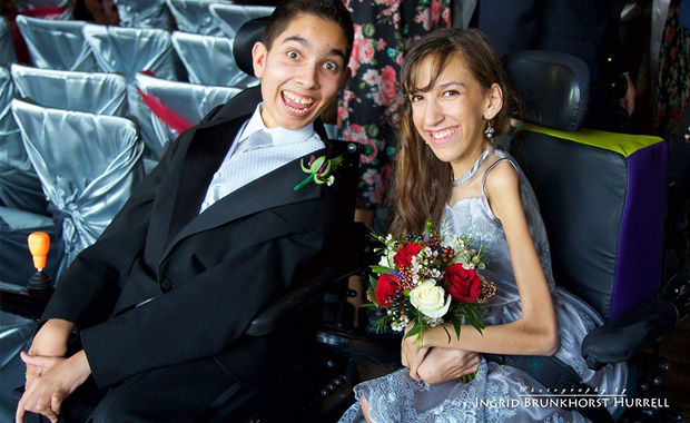 Ishan and Shanaya Manerikar, two teenagers with SMA, in formal wear and smiling happily. Shanaya's holding flowers.