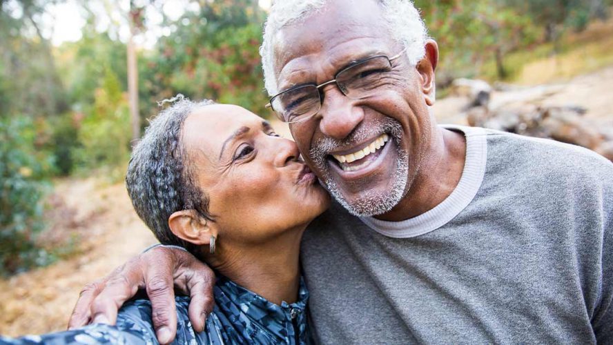 Black senior couple smiling for a kissing selfie