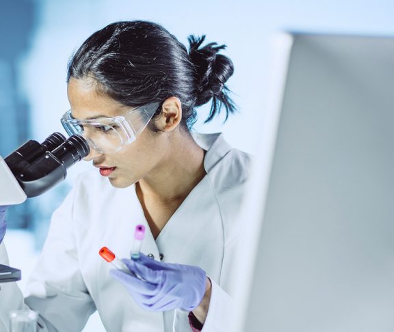 Female scientist working with a microscope 2