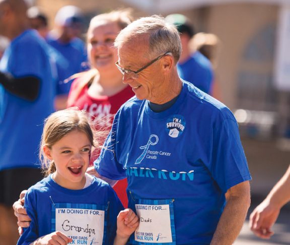 Photograph of a father and his daughter at the Prostate Cancer Canada Walk and Run, participating for their father and grandfather, respectively.