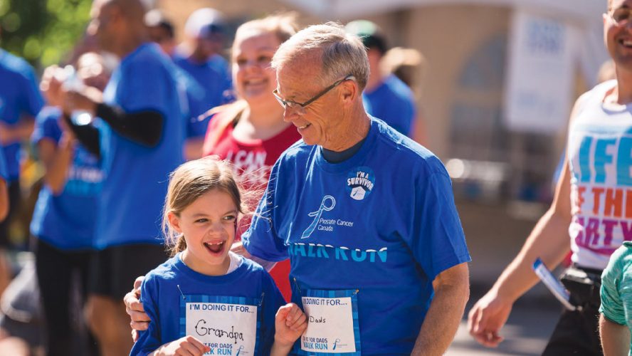 Photograph of a father and his daughter at the Prostate Cancer Canada Walk and Run, participating for their father and grandfather, respectively.