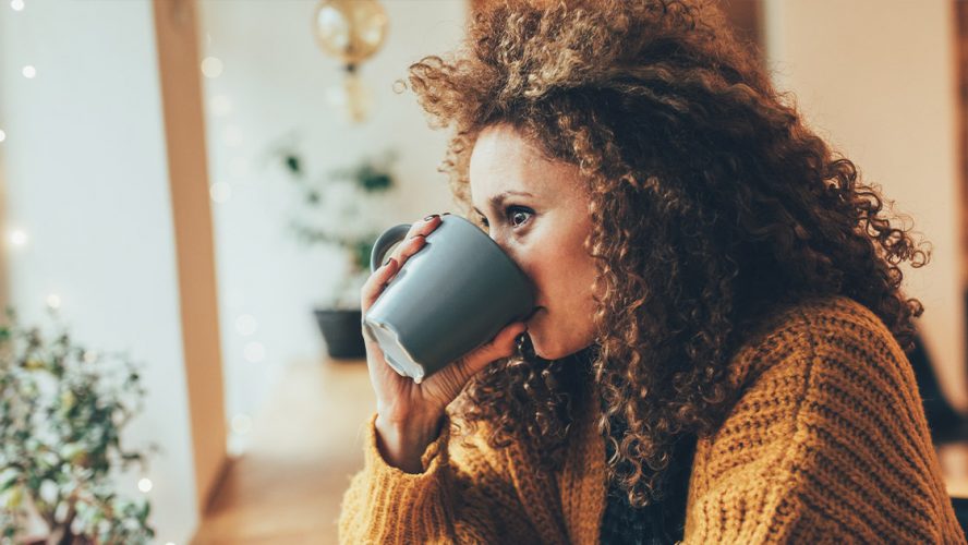 Woman drinking a mug of tea