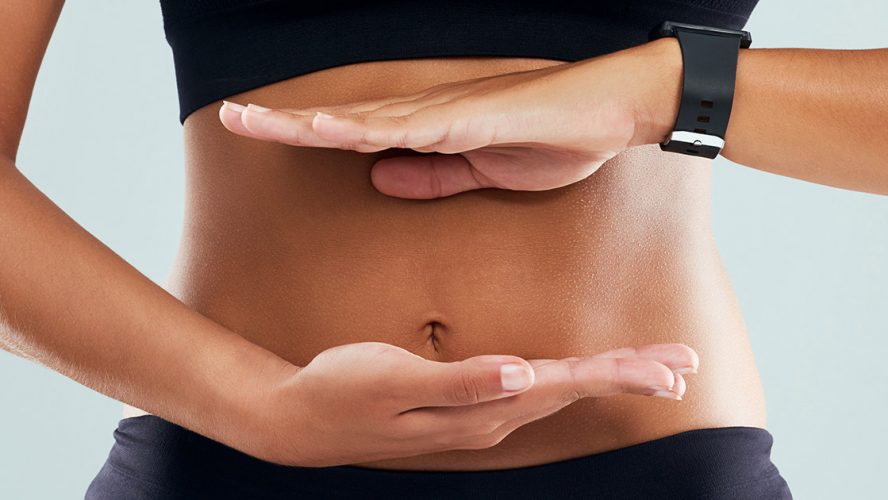 Woman framing her stomach with her hands