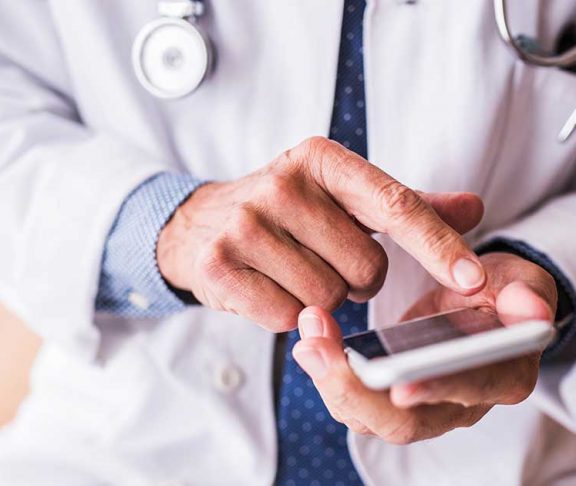 Close-up of doctor using a mobile phone