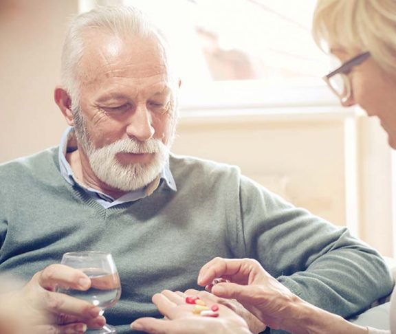 Elderly man learning about his medications