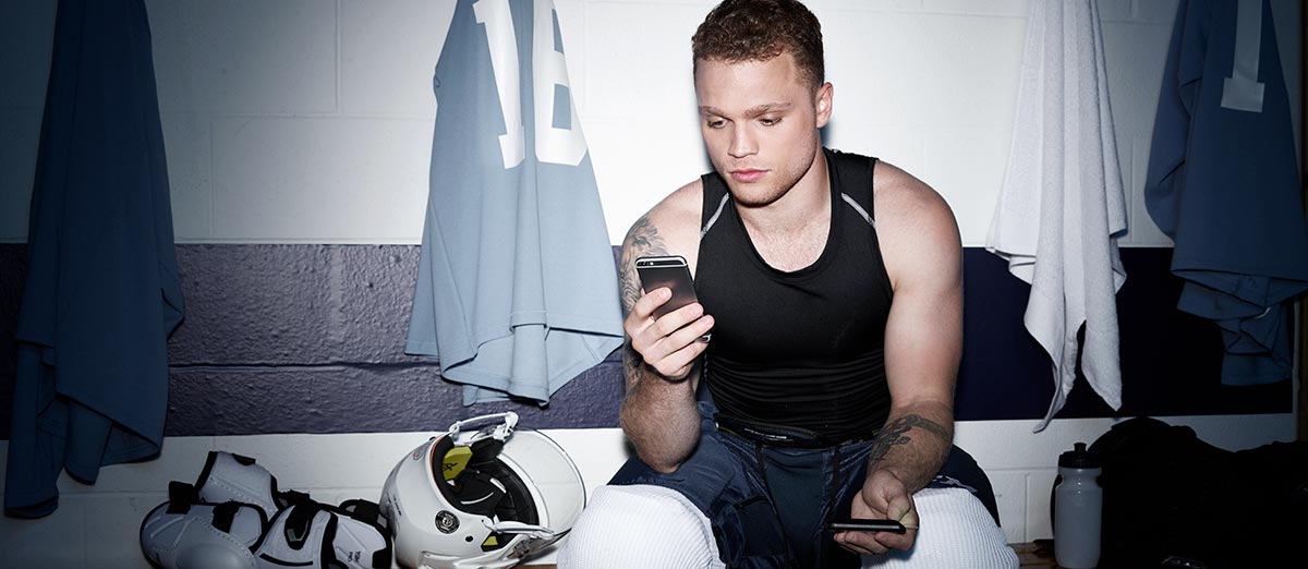 Max Domi using the CONTOUR® DIABETES app in a locker room