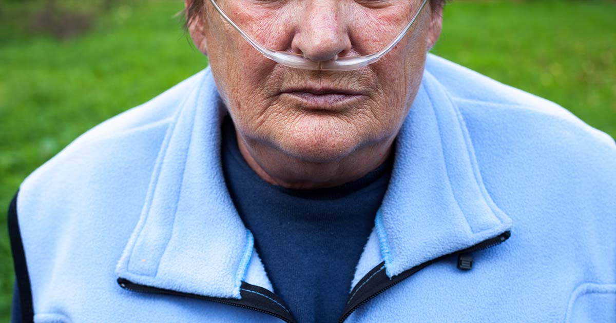 Senior with COPD using an oxygen tube