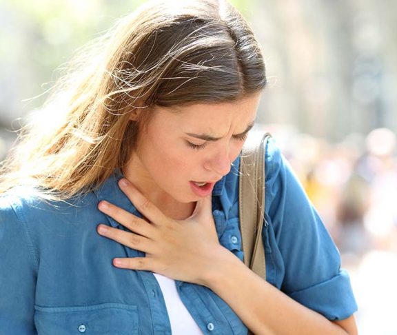Woman having breathing troubles