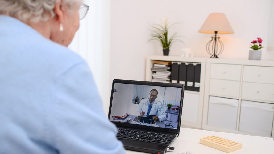 Elderly woman receiving doctor's advice through a computer chat