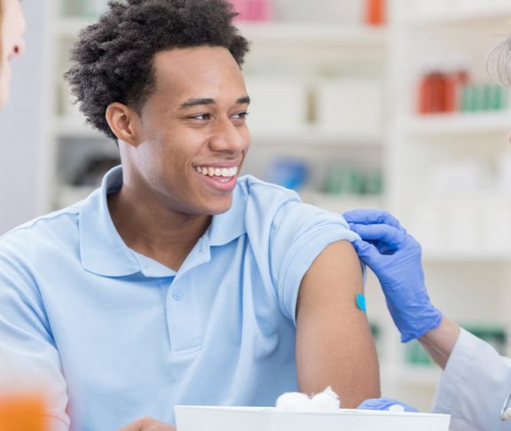 Man getting vaccinated by a pharmacist