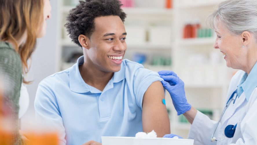 Man getting vaccinated by a pharmacist