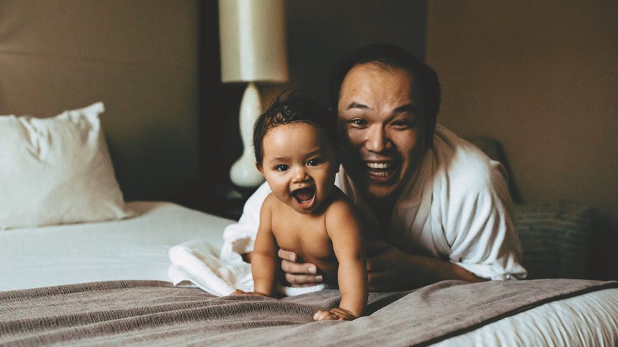 Nathan Chan and his baby, both grinning