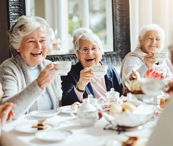 Senior women enjoying high tea together
