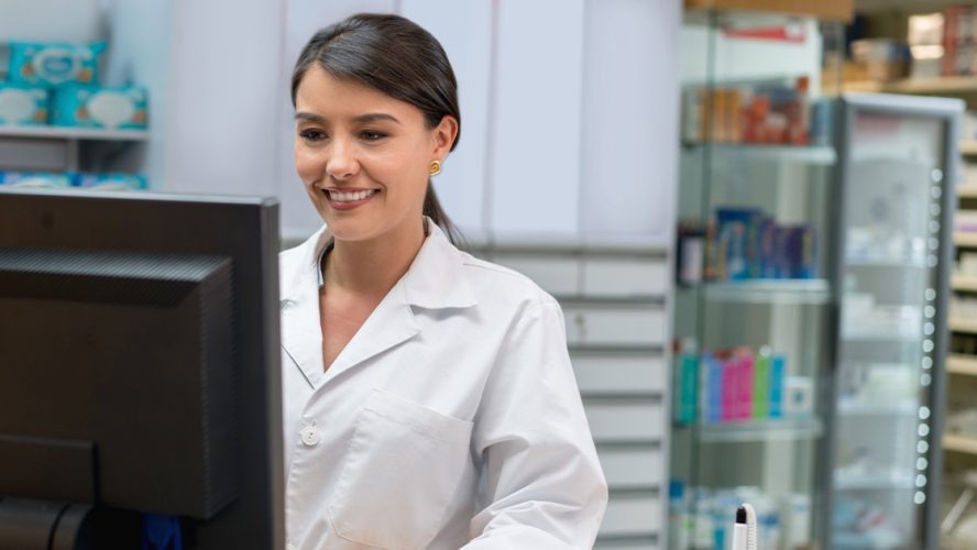 Female pharmacist working at desk