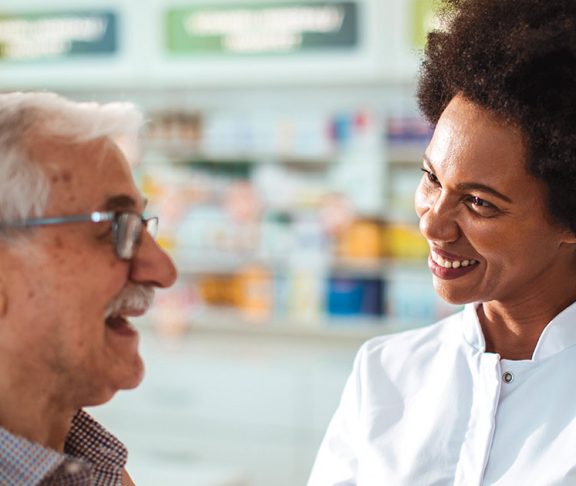 Pharmacist helping an elderly man