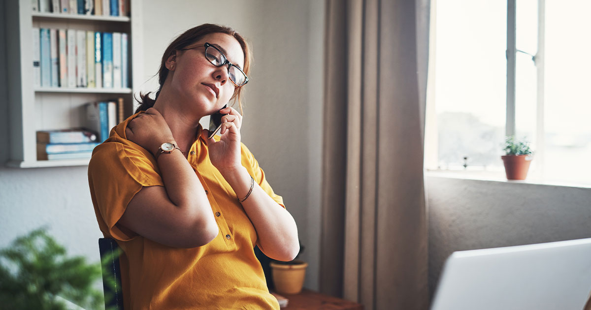 Woman having a difficult phone conversation at home