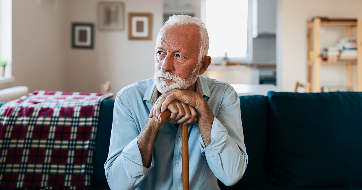 Elderly man sitting alone at home