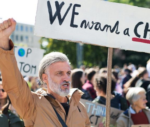 Grey-haired man marching in a protest