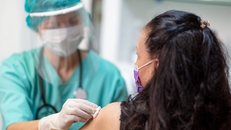 Woman getting a flu shot during COVID-19