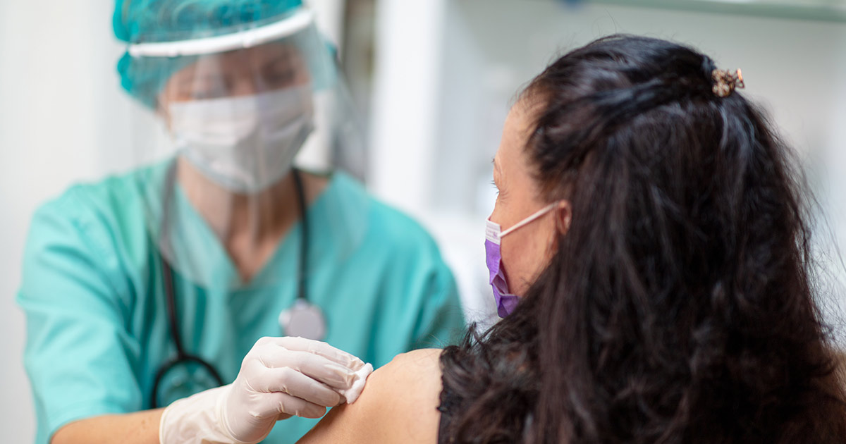 Woman getting a flu shot during COVID-19