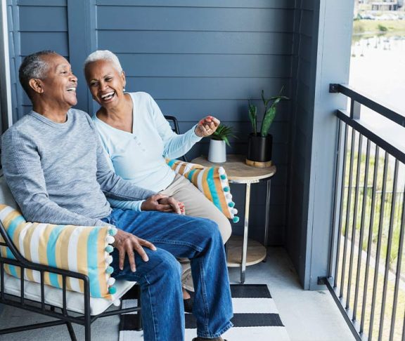 Two seniors enjoying time on their porch