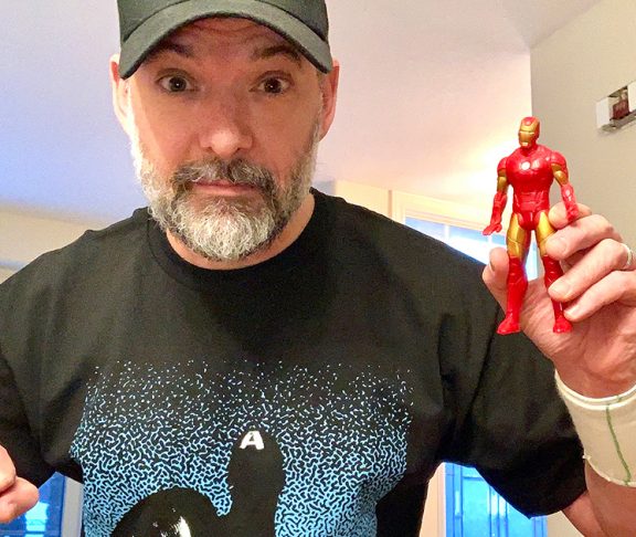 Steven Gallagher holding Iron Man Figurine