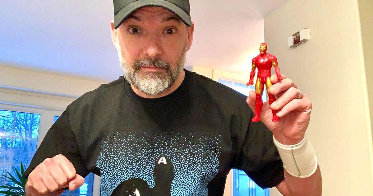 Steven Gallagher holding Iron Man Figurine