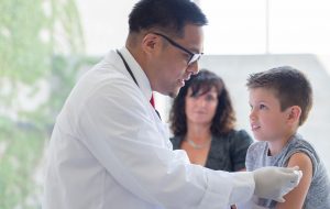 Young boy getting a vaccination at a doctor's appointment
