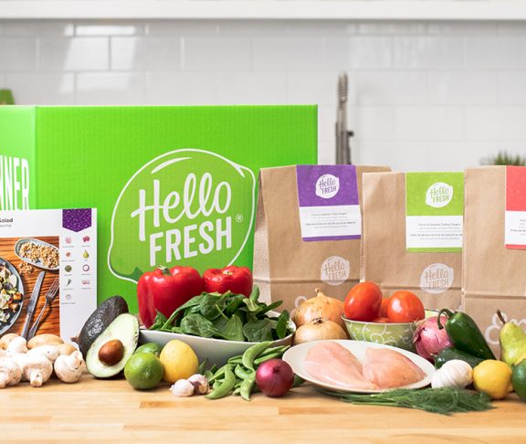 Several Hello Fresh Meal Kits are laid out on the table