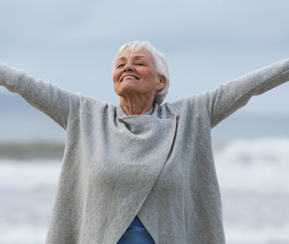 Happy Elderly Woman With Hands Up