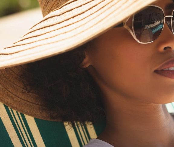 woman sunbathing with cap