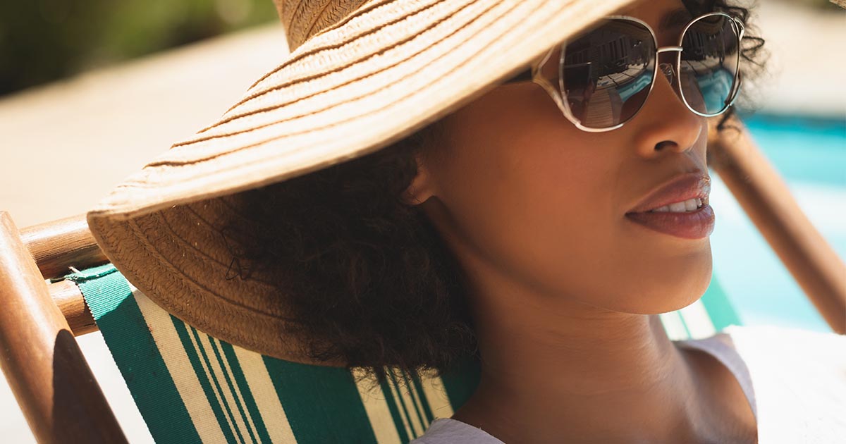 woman sunbathing with cap