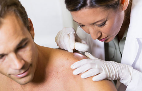 dermatologist-examining-patients-skin-for-signs