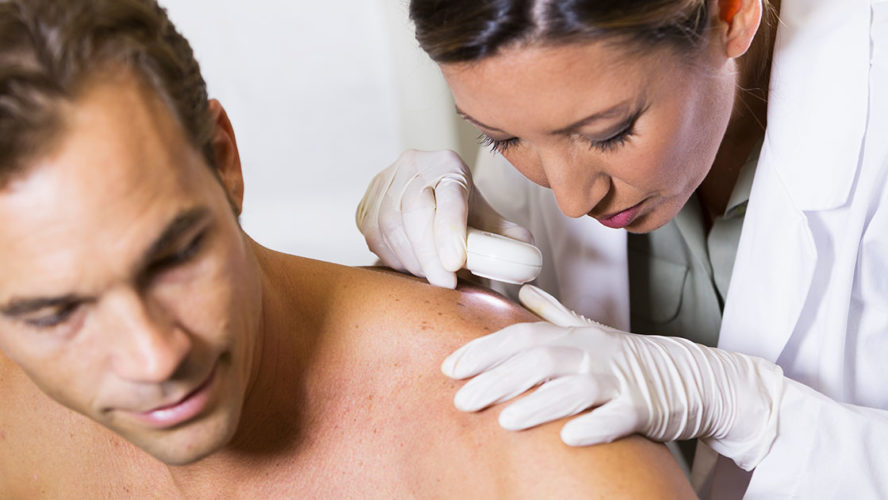 dermatologist-examining-patients-skin-for-signs