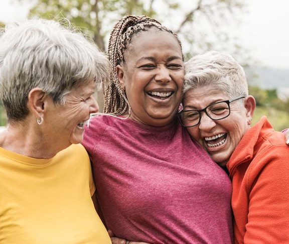 older women smiling laughing