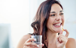 young woman smiling eating drinking