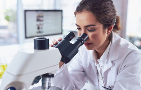 female scientist in lab microscope