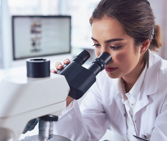 female scientist in lab microscope