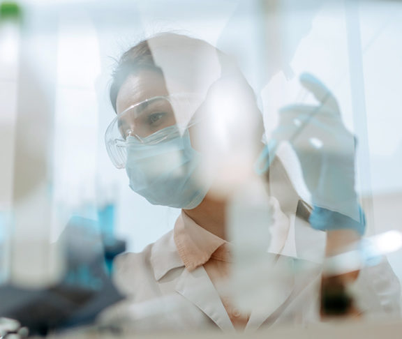 researcher in lab with mask