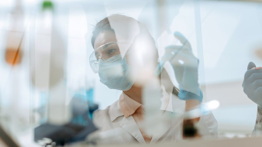 researcher in lab with mask