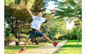 young asian man jumping in air