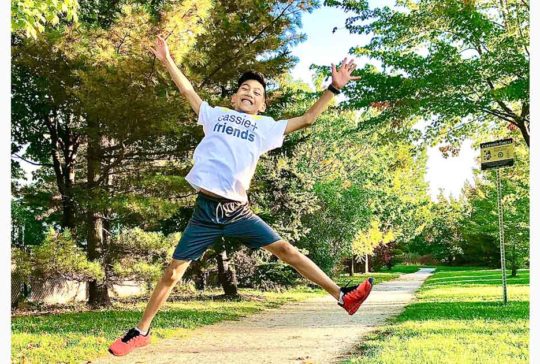 young asian man jumping in air