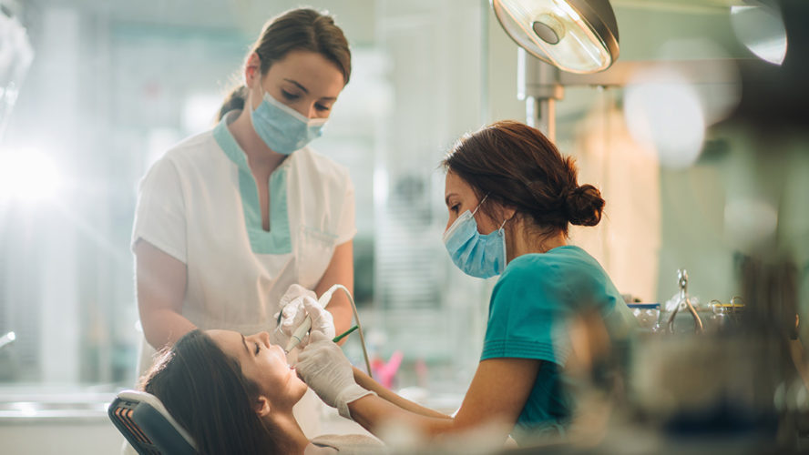 dental nurses operating on patient