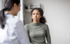 young woman talking with doctor