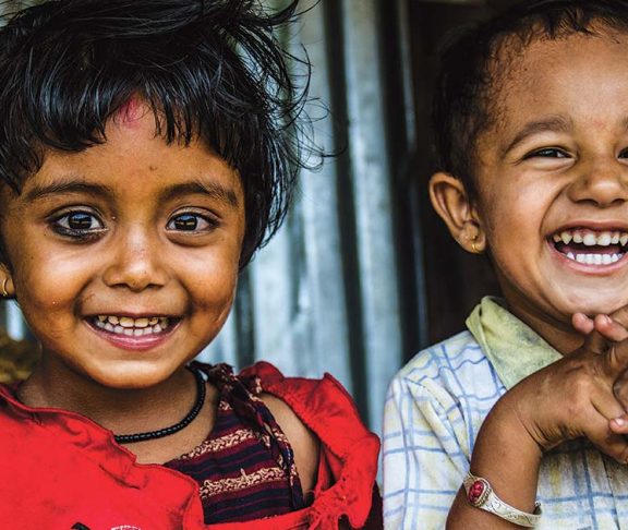 Two smiling young girls in South Asia