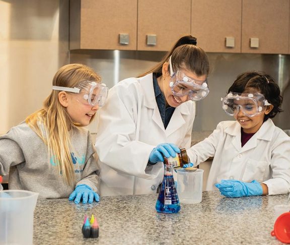 Three girls enjoying a science experiment